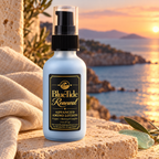 BlueTide Renewal lotion bottle on pale stone beside linen at sunset.