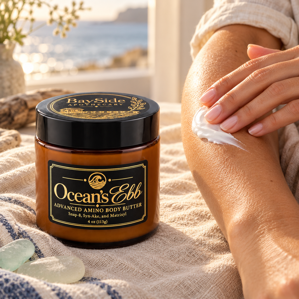 White Ocean's Ebb body butter being smoothed onto an arm beside its amber jar.