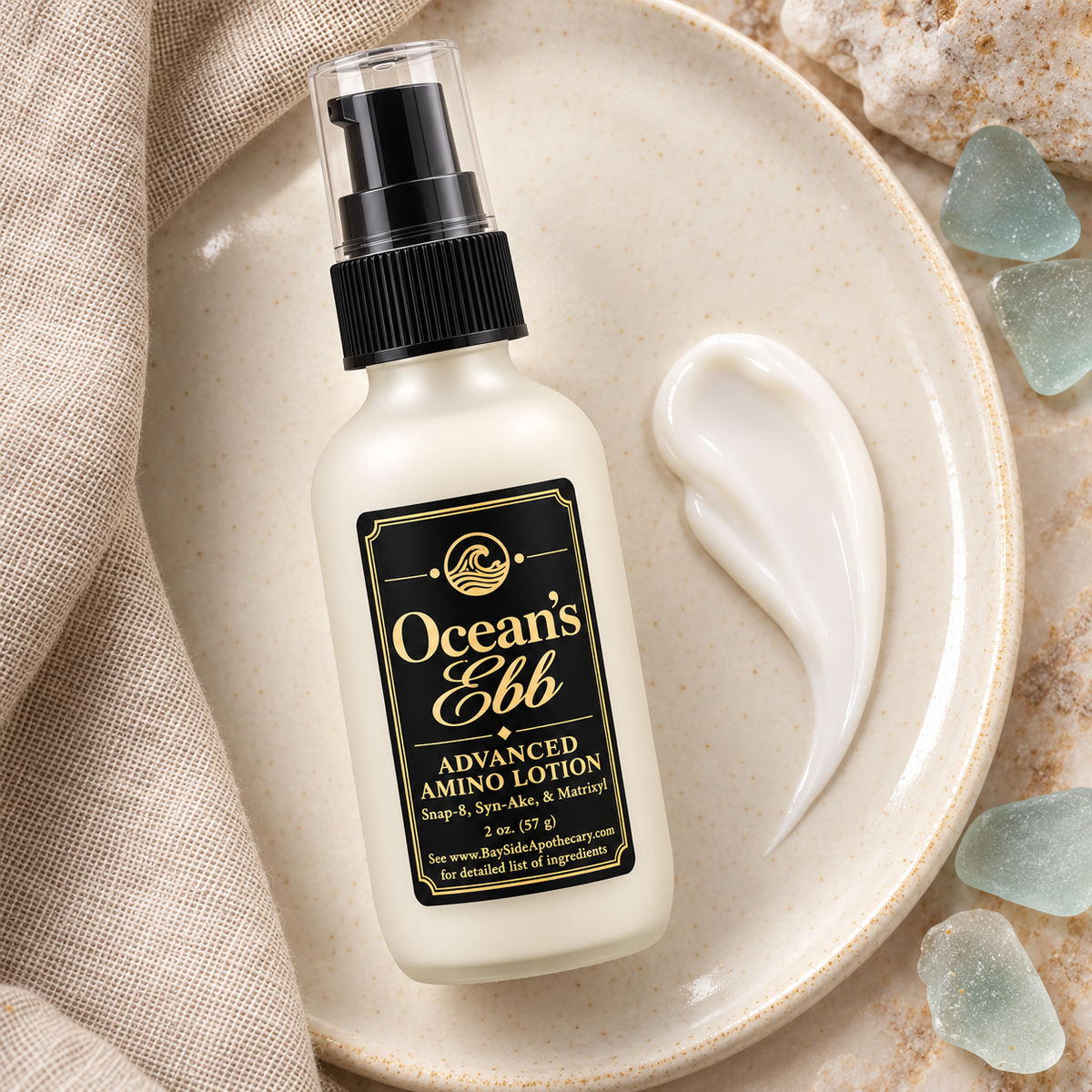 Ocean's Ebb lotion bottle beside a smooth white lotion swatch on ivory ceramic.