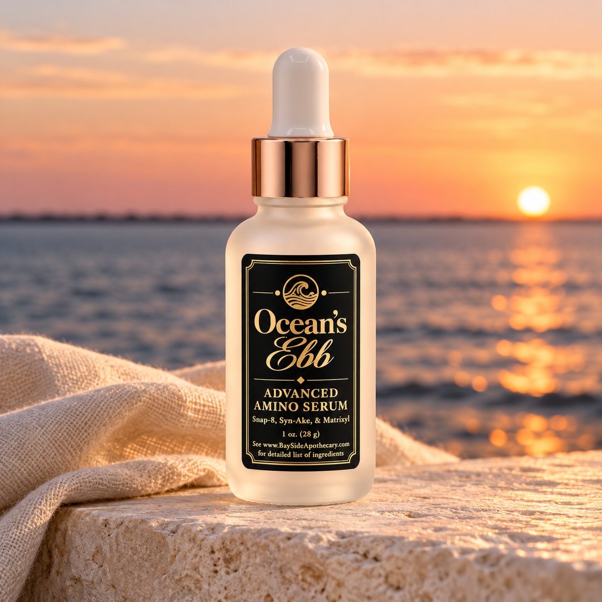 Ocean's Ebb serum in its frosted dropper bottle beside the bay at sunset.