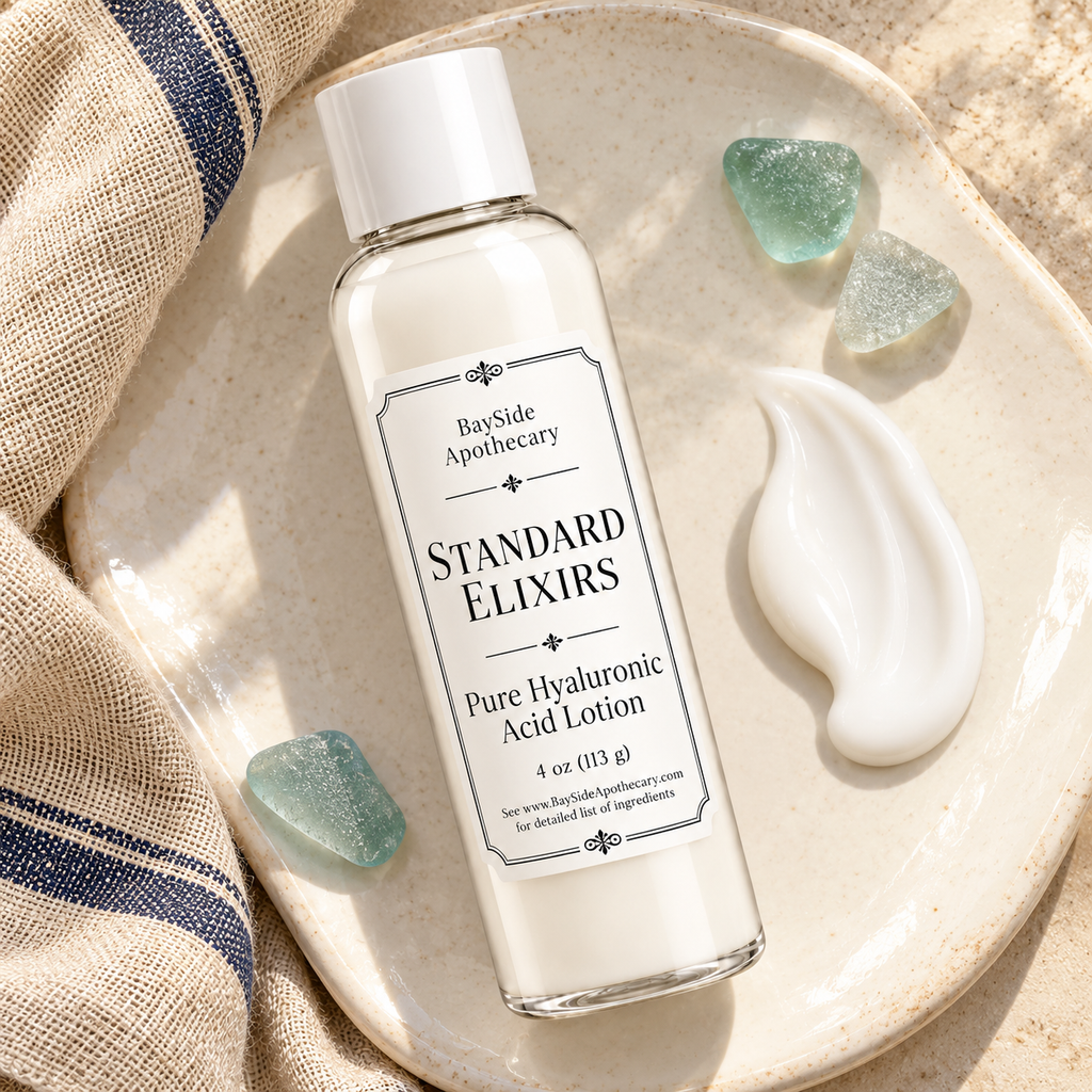 Standard Elixirs lotion bottle beside a smooth white lotion swatch on ivory ceramic.