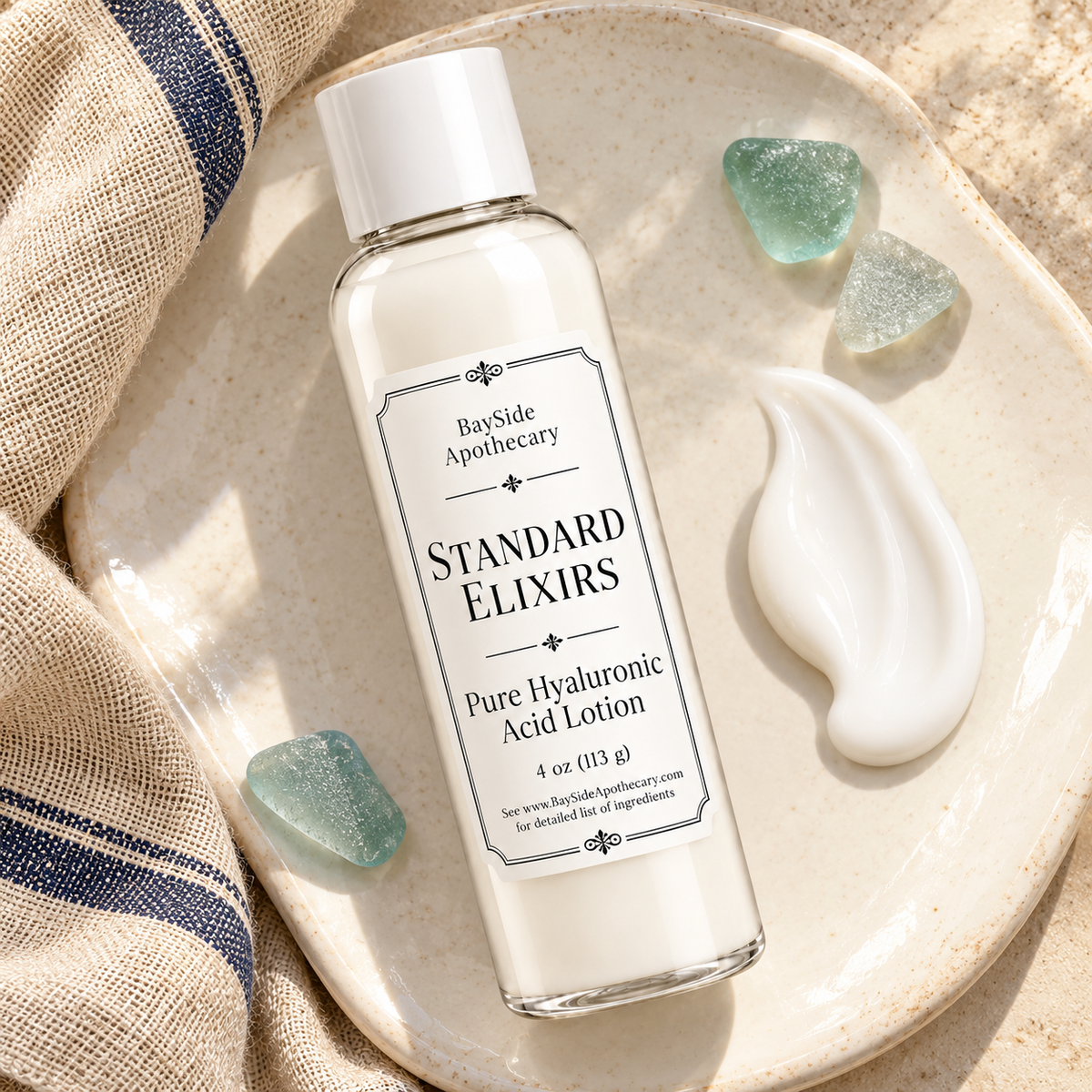 Standard Elixirs lotion bottle beside a smooth white lotion swatch on ivory ceramic.